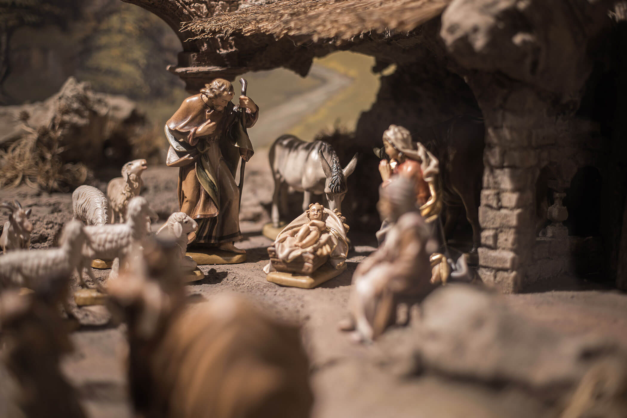 Nativity scene with figurines of Mary, Joseph, baby Jesus in a manger, animals, and shepherds. - Hotel Innerhofer